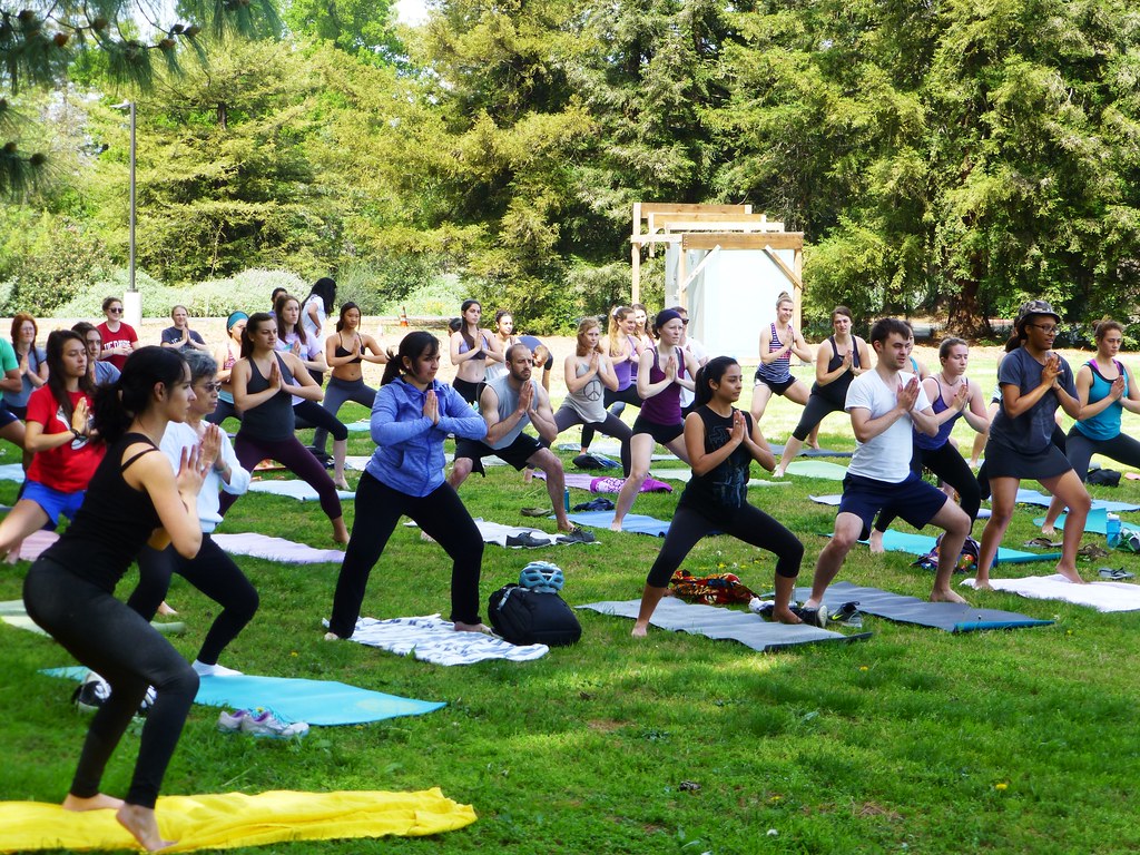 A yoga class outside on the lawn on a nice Spring day.